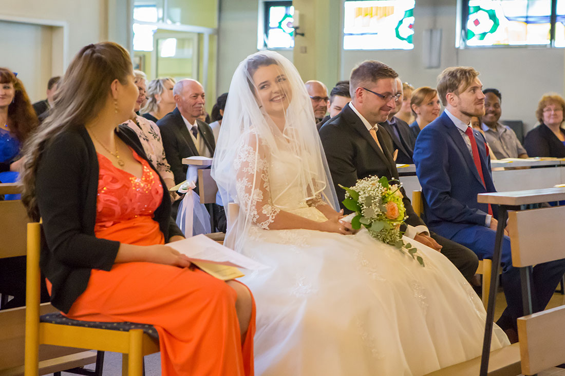 Hochzeit-Trauung-Kirche-St.-Andreas-Kirche-Meine-Braut-lacht-ihre-Trauzeugin-an-Freude-Erleichterung-Sergej-Metzger-Hochzeitsvideo-Hannover-Fotograf-Hildesheim